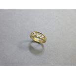 A band ring set with five old cut diamonds, the graduated old cushion and oval cut diamonds claw set