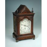 A Regency rosewood mantel timepiece of small proportions, the triangular pediment with fan moulding,