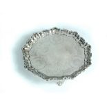 A George III silver salver, by Walter Brind, London 1810, the foliate engraved field with a