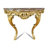 A carved giltwood console table - 19th century, of serpentine outline, the pink grained marble to