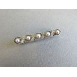 An early 20th century Swiss pearl, diamond and platinum bar brooch, featuring a line of five