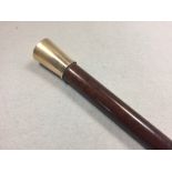 A good malacca walking cane with precious yellow metal mount, tests as 9ct gold, the top engraved