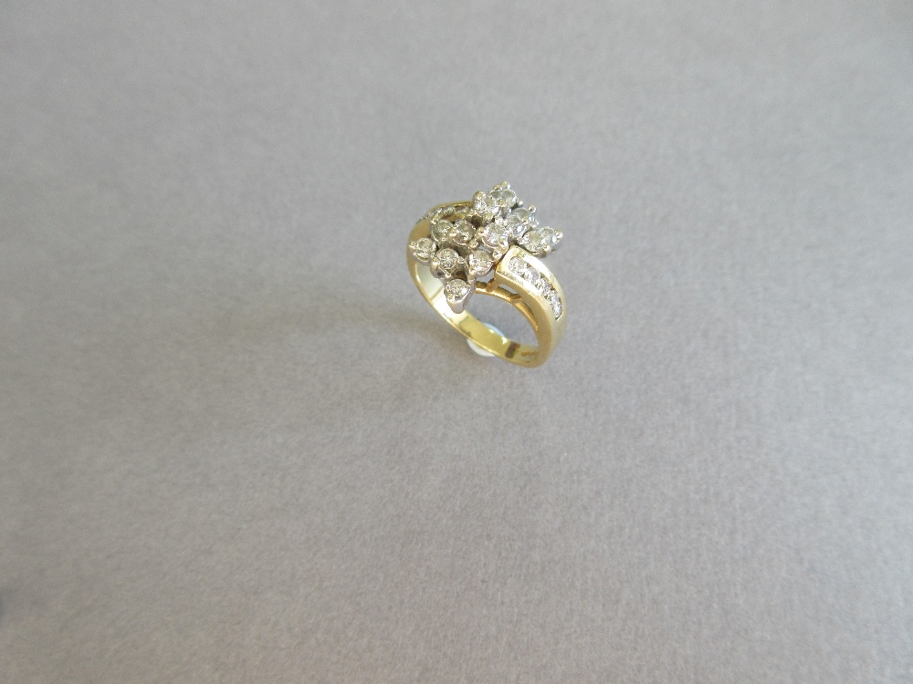 An asymmetrical diamond cluster ring, with a pierced bow form composed of tiered round brilliant cut - Image 5 of 5