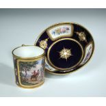 A 19th century 'Sevres' jewelled bleu de Roi coffee can and saucer, the former painted with two