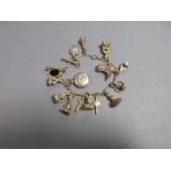 A fancy link charm bracelet suspending a quantity of miniature hardstone fob seals and other various