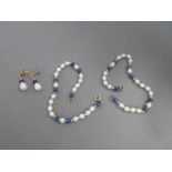 A lapis lazuli and cultured pearl matched suite of earrings and two bracelets, each strung