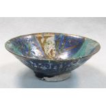 A Nishapur pottery footed bowl, probably 12th century, decorated with stylised fish on a blue and