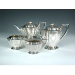 An American four piece silver tea service, the hot water jug, cream jug and sucrier by Mermod