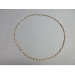 A fancy link chain necklace, each link designed as two narrow horseshoes joined at the tips at