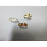 A seed pearl ring by Murrle Bennett, an earlier five stone hessonite garnet ring and a claddagh