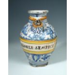 A 17th century Italian maiolica syrup or wet drug jar, the ovoid body extensively painted in blue