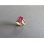 A synthetic pink sapphire ring, the cushion shaped fancy cut vivid pink sapphire claw set to broad