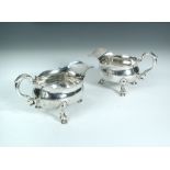 A near pair of George II silver sauce boats, by John Eckford II, London 1736, with shaped rims and