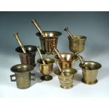 A collection of eight 18th century and later bronze and brass pestles and mortars, the eight mortars