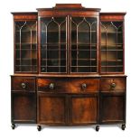 A Regency mahogany breakfront secretaire bookcase, with bow front central section and cornice with a