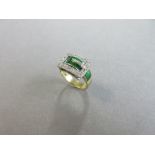 An 18ct gold diamond and enamel buckle ring, the front of the band with green guilloche enamel,