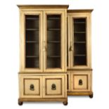 A pair of decorative painted French bibliotheques, with brass grill doors and cupboards to the