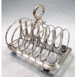 A William IV silver seven bar toast rack, by Benjamin Preston, London 1837, on cast rectangular