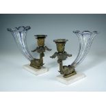 A pair of Regency bronze mounted glass cornucopia, with elephant head terminals, mounted to marble