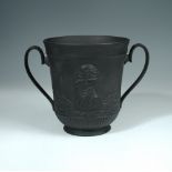 A Davenport basalt two-handled commemorative loving cup for Captain James Cook, the body moulded