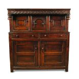 A Welsh oak court cupboard - late 17th/early 18th century, the overhung cornice decorated with