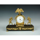 A Regency bronze and ormolu mantel timepiece, with eagle crest and two winged putti flanking the 9cm