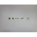 A collection of loose fancy yellow round brilliant cut diamonds, of varying shades and saturations