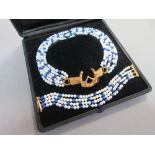 A lapis lazuli and cultured pearl necklace with diamond set horseshoe and bit feature clasp, and
