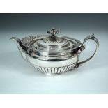 A George IV silver melon shaped teapot, by William Eley II, London 1823, the half lobed bat winged