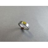 A fancy yellow marquise cut diamond and platinum ring, the D-section band with polished inner