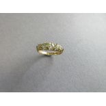 An antique five stone diamond ring set in 18ct gold, the graduated old round brilliant cut