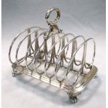 A Victorian silver seven bar toast rack, by Robert Garrard, London 1874, the cast rectangular base