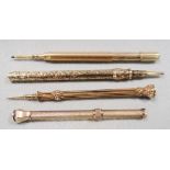 Four gilt metal propelling pencils. A Butler & Co gilt metal propelling pencil set with an amethyst;