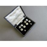 A sapphire and mother-of-pearl gentleman's dress set in fitted case, the double-ended cufflinks,