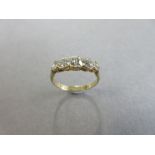 A five stone diamond ring, the five graduated old round brilliant cut diamonds in a continuous