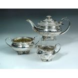 A George IV silver three piece teaset, by Joseph Angell II, London 1820, comprising:- a teapot of