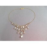 An 18ct gold and moonstone bib necklace by Chroussis, composed of oval cabochon spectacle set