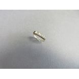 A baguette cut diamond half hoop ring, the close set line of very slightly graduated baguette cut