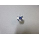 An Art Deco sapphire and diamond ring, the principal slightly oval sapphire collet set in the centre