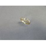 An Edwardian style five stone diamond ring, the graduated old round or cushion cut diamonds claw set