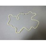 An opera length string of graduated cultured pearls, the 4.3-8.5mm pearls, individually knotted,