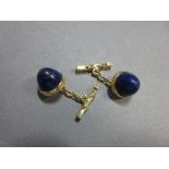 A pair of lapis lazuli cufflinks, each with a round sugar-loaf cabochon lapis lazuli, collet set,