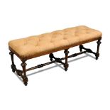 An oak framed long stool - late 19th century, button upholstered in tan suede leather, on turned