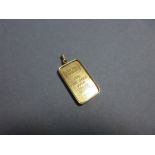 A 20g pure gold ingot by Credit Suisse set in a pendant, the cushion cornered rectangular ingot