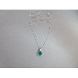 An emerald and diamond pendant with white gold chain, the oval cut emerald four claw set with a