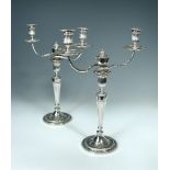 A pair of George III silver neo-classical two branch candelabra, the candlesticks by John