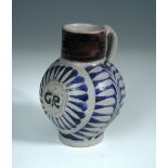 An 18th century German Westerwald stoneware jug, the globular body monogramed with the initials 'GR'