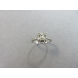 A rectangular diamond cluster ring, the principal diamond an emerald cut stone with a baguette cut