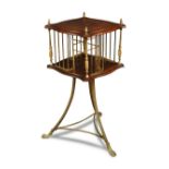 An Edwardian mahogany revolving bookstand, with gilt brass divisions, columns and finials, on