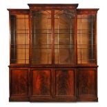 A George IV mahogany breakfront library bookcase, with a raised central section and arched